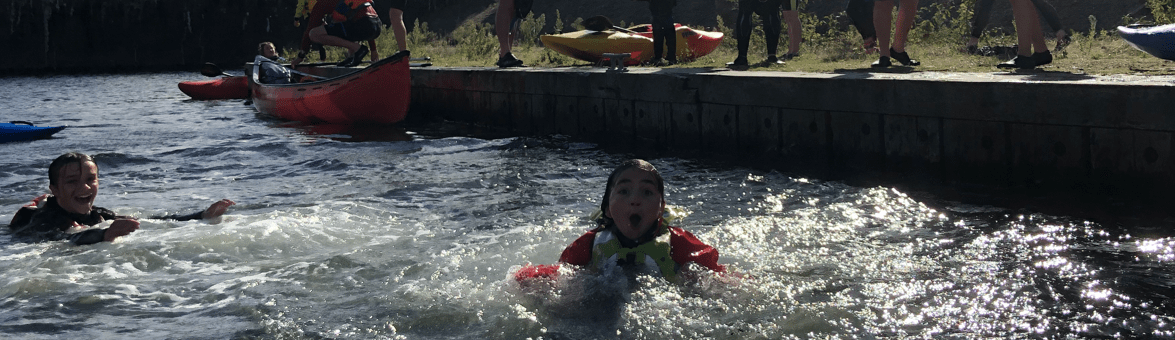 A group of people in the waterDescription automatically generated with low confidence