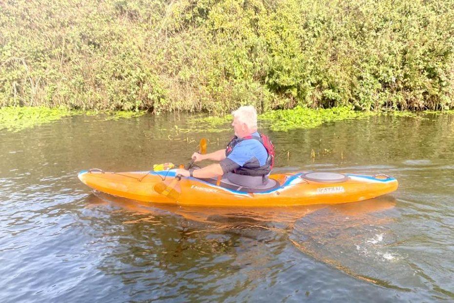 A person in a kayak on a river Description automatically generated with low confidence