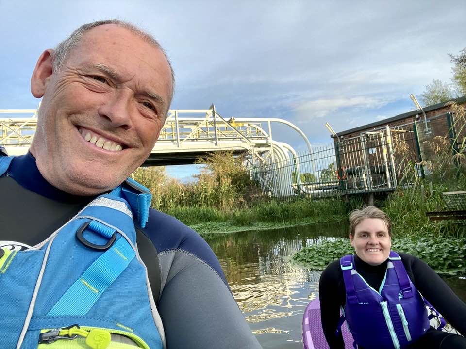 May be an image of 2 people, people sitting and body of water