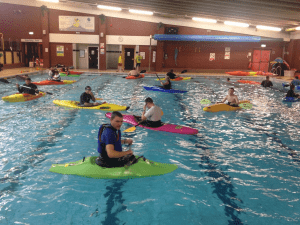 A group of people in a pool Description automatically generated with medium confidence