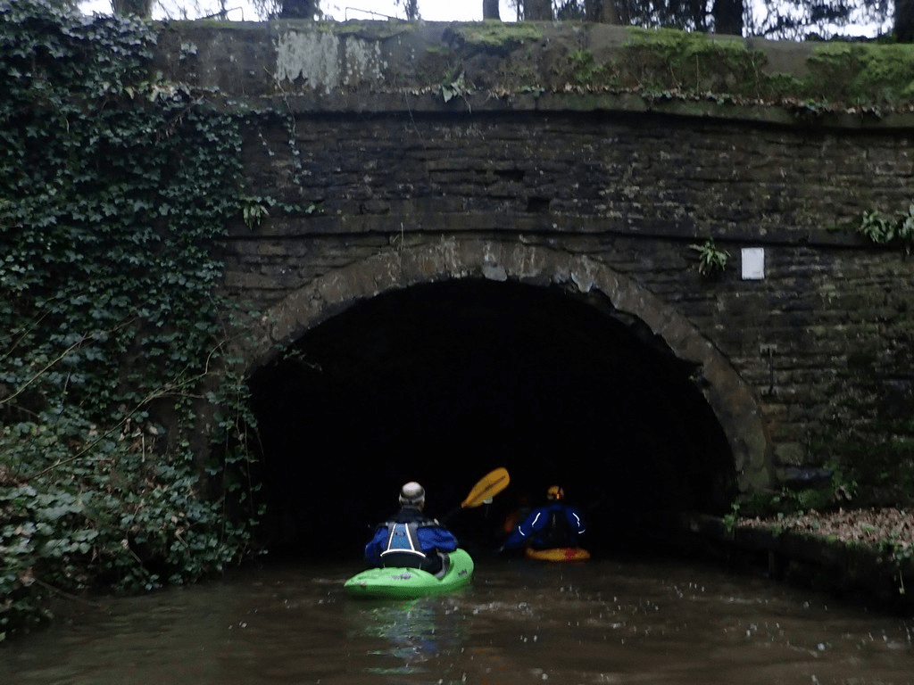 A group of people in kayaks in a riverDescription automatically generated with low confidence