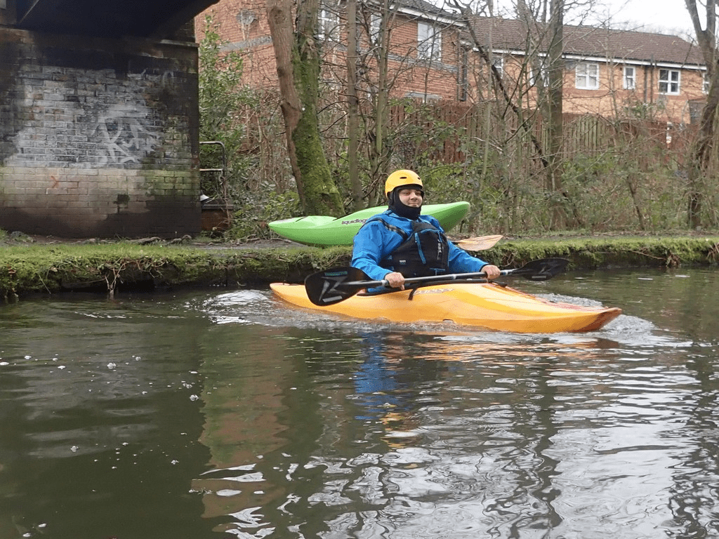 A person in a kayakDescription automatically generated with medium confidence