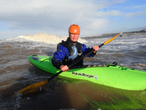 A person in a kayak Description automatically generated with medium confidence