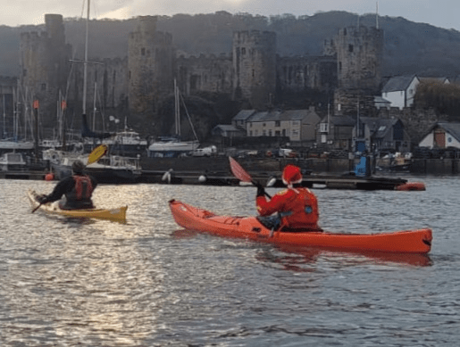 A picture containing boat, water, outdoor, orangeDescription automatically generated