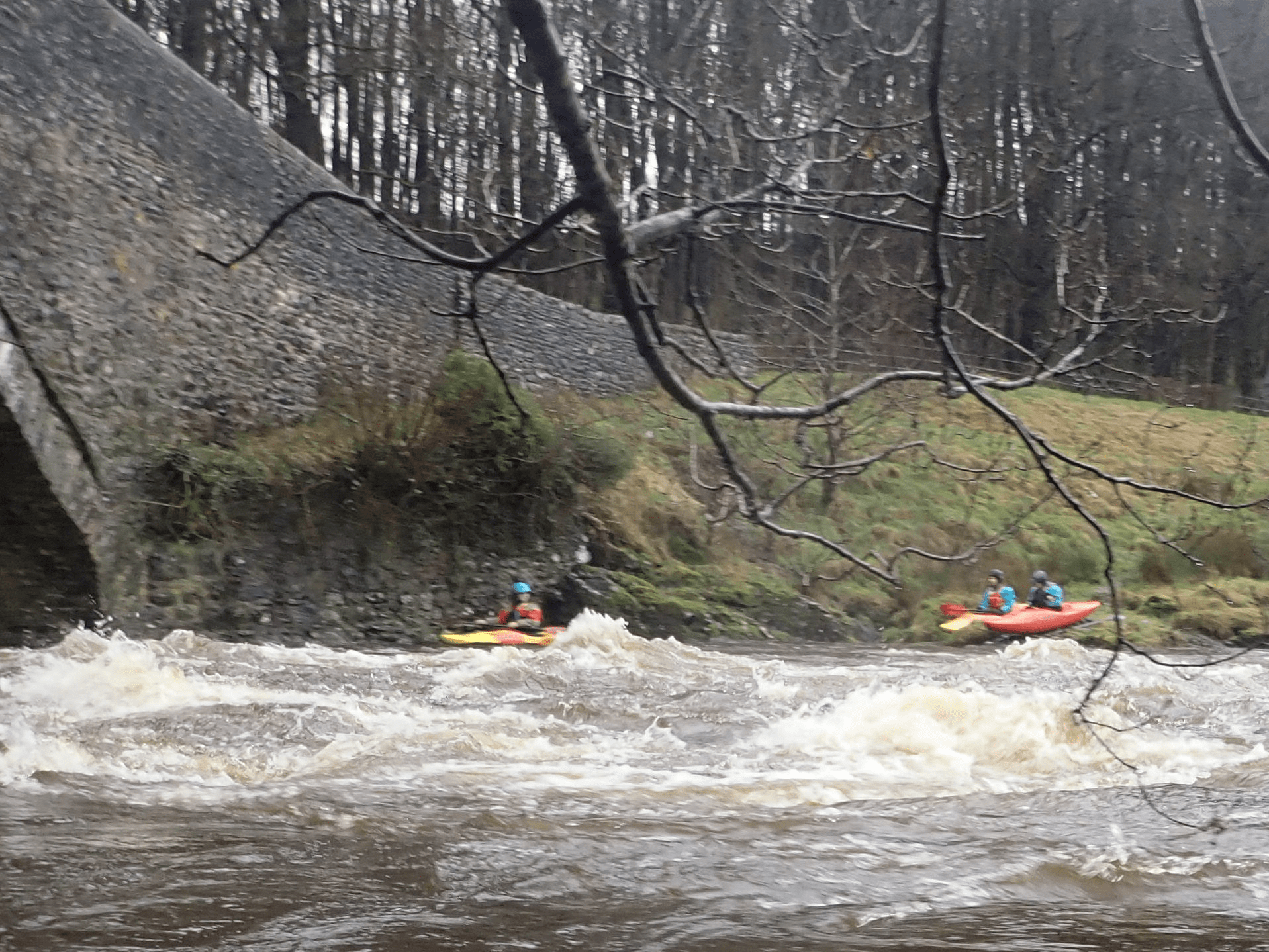A group of people in kayaks going down a riverDescription automatically generated with medium confidence