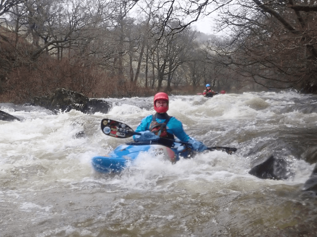 A person in a kayak in a riverDescription automatically generated with medium confidence