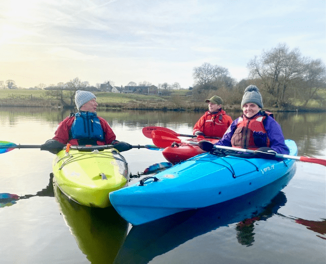 A group of people in kayaksDescription automatically generated with medium confidence