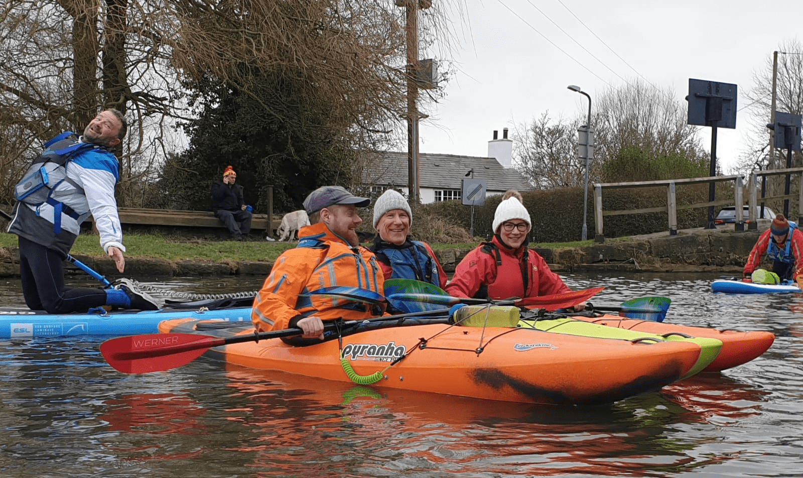 A group of people in kayaksDescription automatically generated with medium confidence