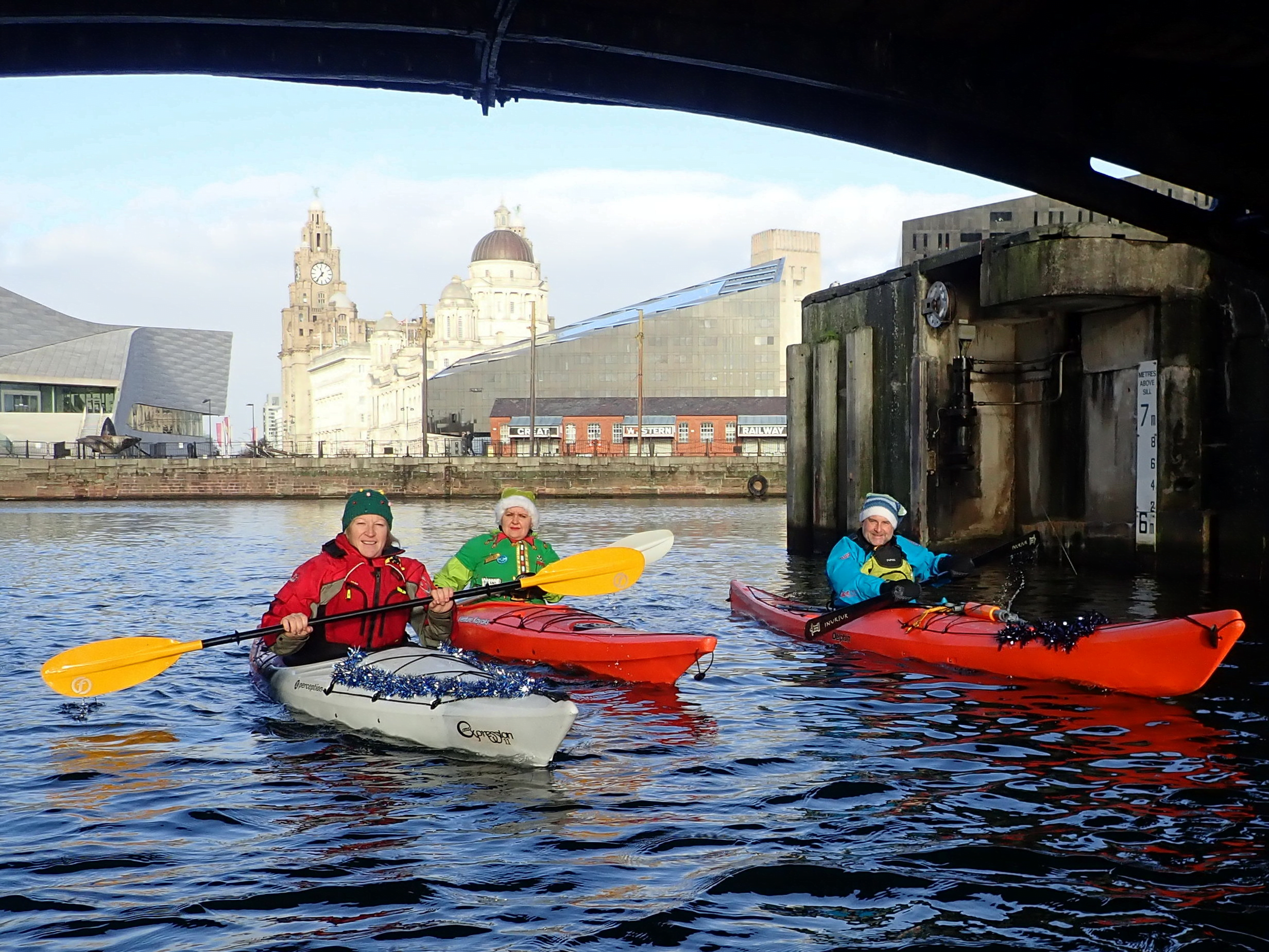 A group of people in kayaksDescription automatically generated with medium confidence