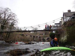 A group of people on a bridge Description automatically generated with low confidence