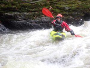 A person kayaking in a river Description automatically generated with medium confidence