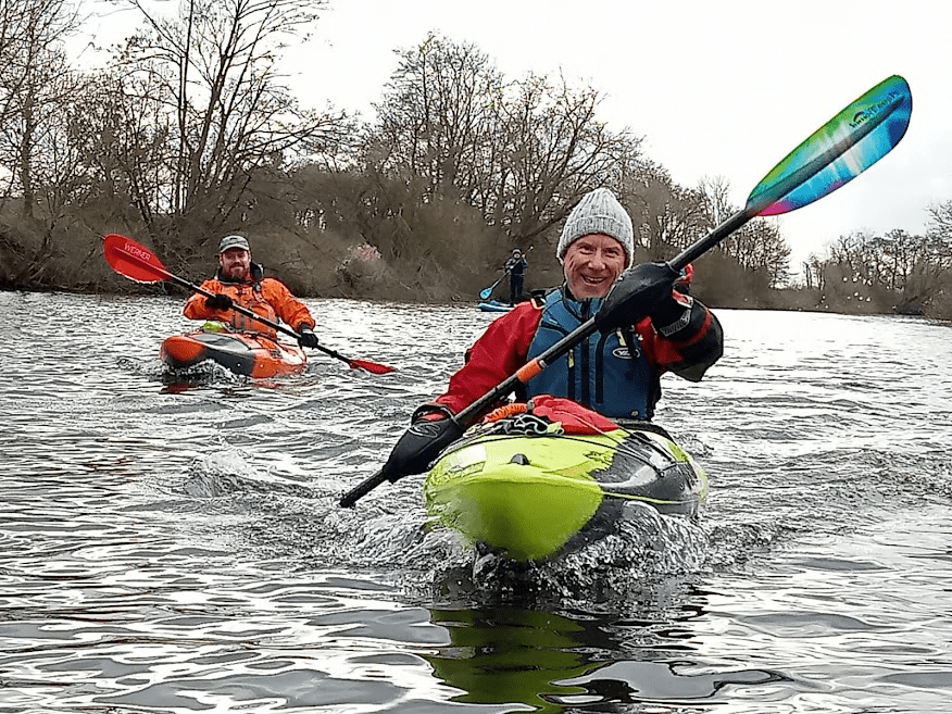 A picture containing water, outdoor, tree, sportDescription automatically generated