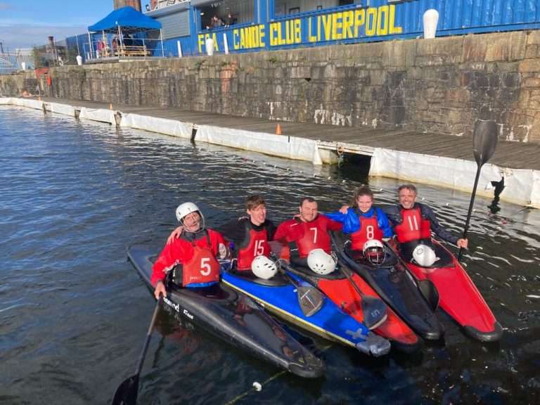 A group of people in a boat Description automatically generated with medium confidence