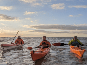A group of people in canoes Description automatically generated with medium confidence