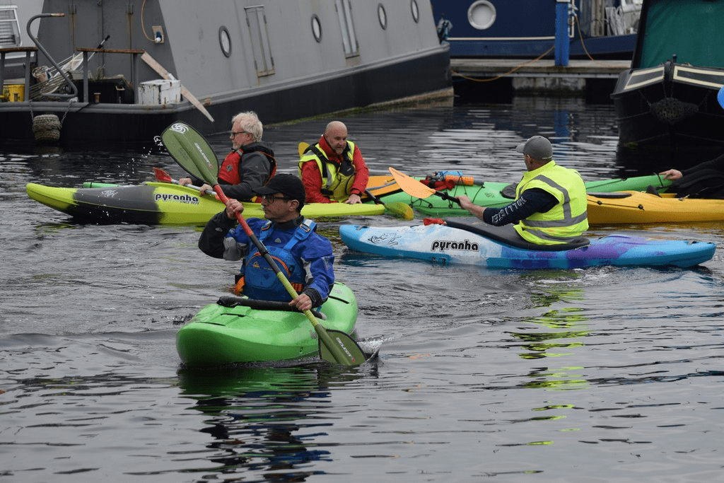 A group of people in kayaks

Description automatically generated with medium confidence