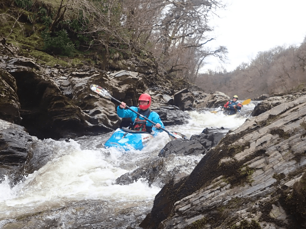 A person in a kayak in a riverDescription automatically generated with low confidence
