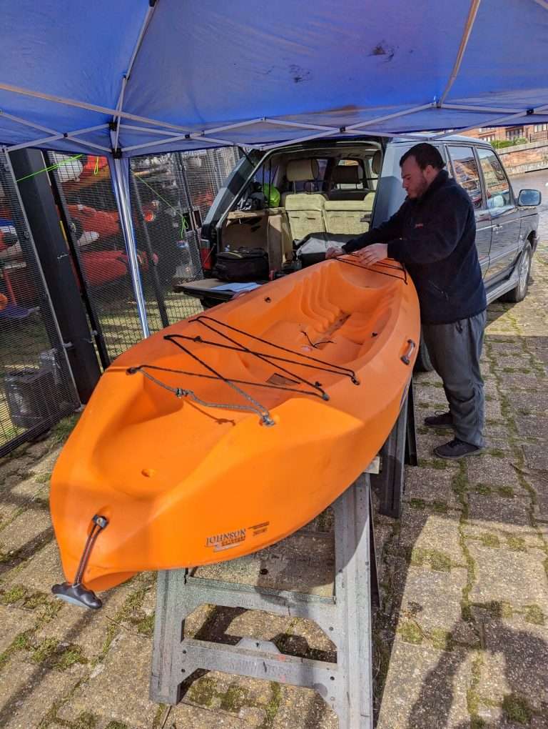 A person stands under an umbrella Description automatically generated with medium confidence