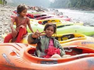 A picture containing child, outdoor, little, boat Description automatically generated