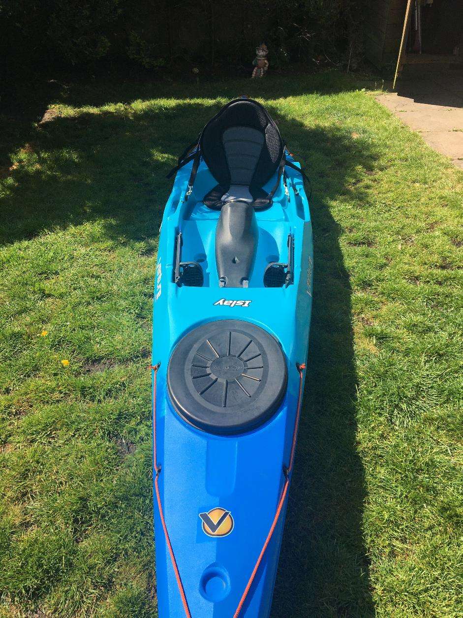A blue kayak on grassDescription automatically generated with medium confidence