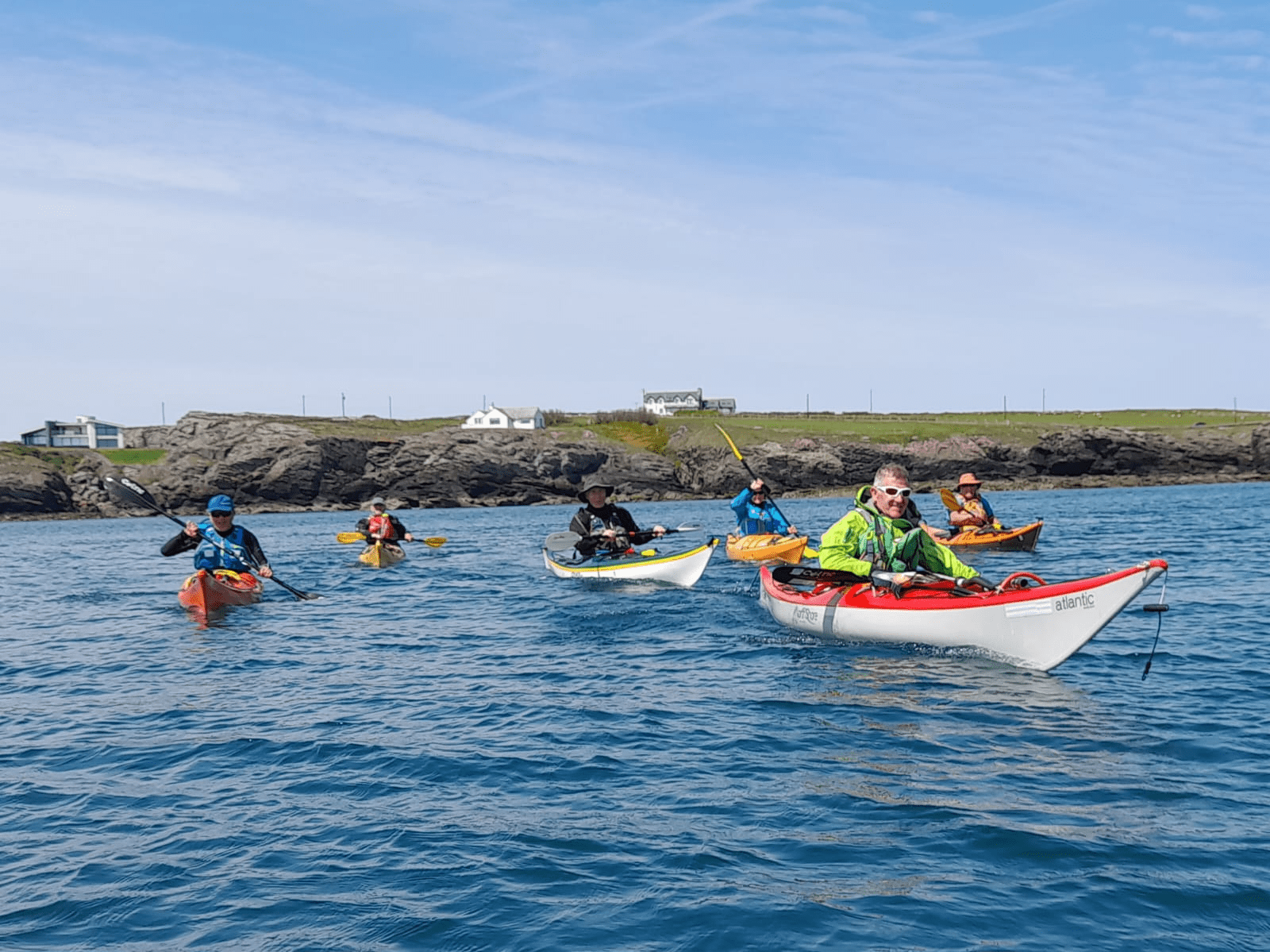 A group of people in kayaks on the waterDescription automatically generated with medium confidence