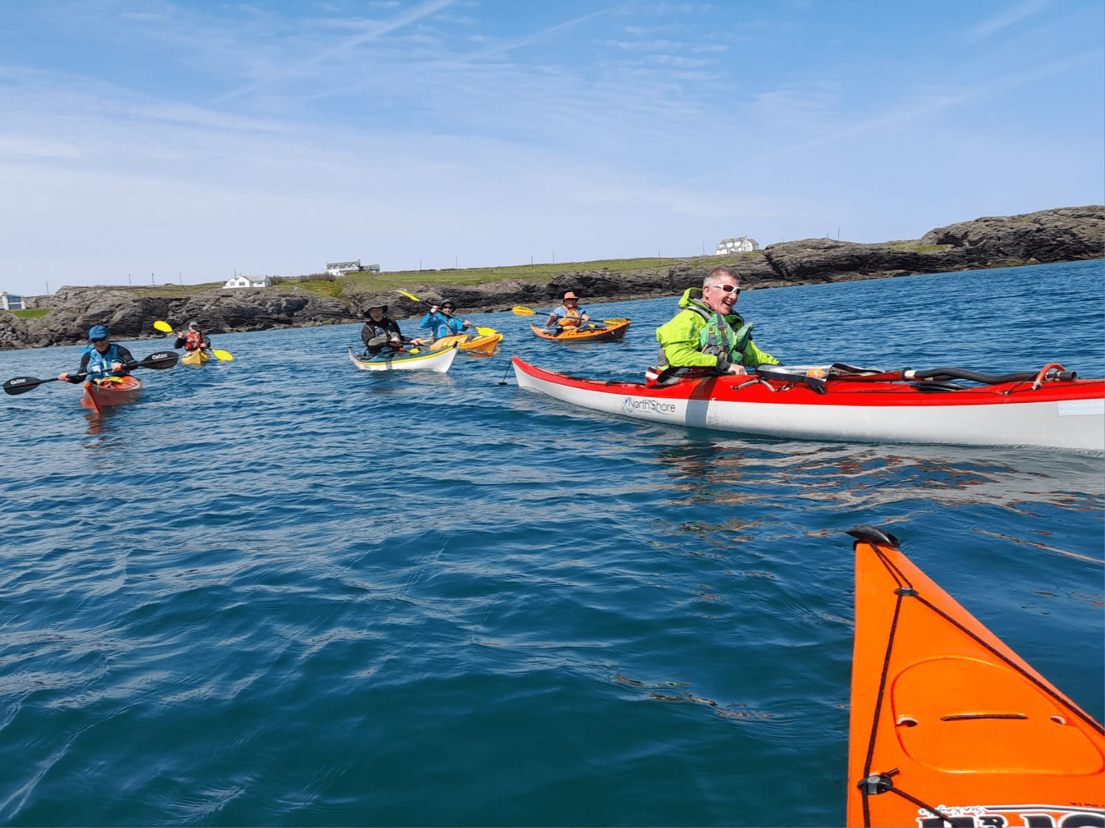 A group of people in kayaks on the waterDescription automatically generated with medium confidence