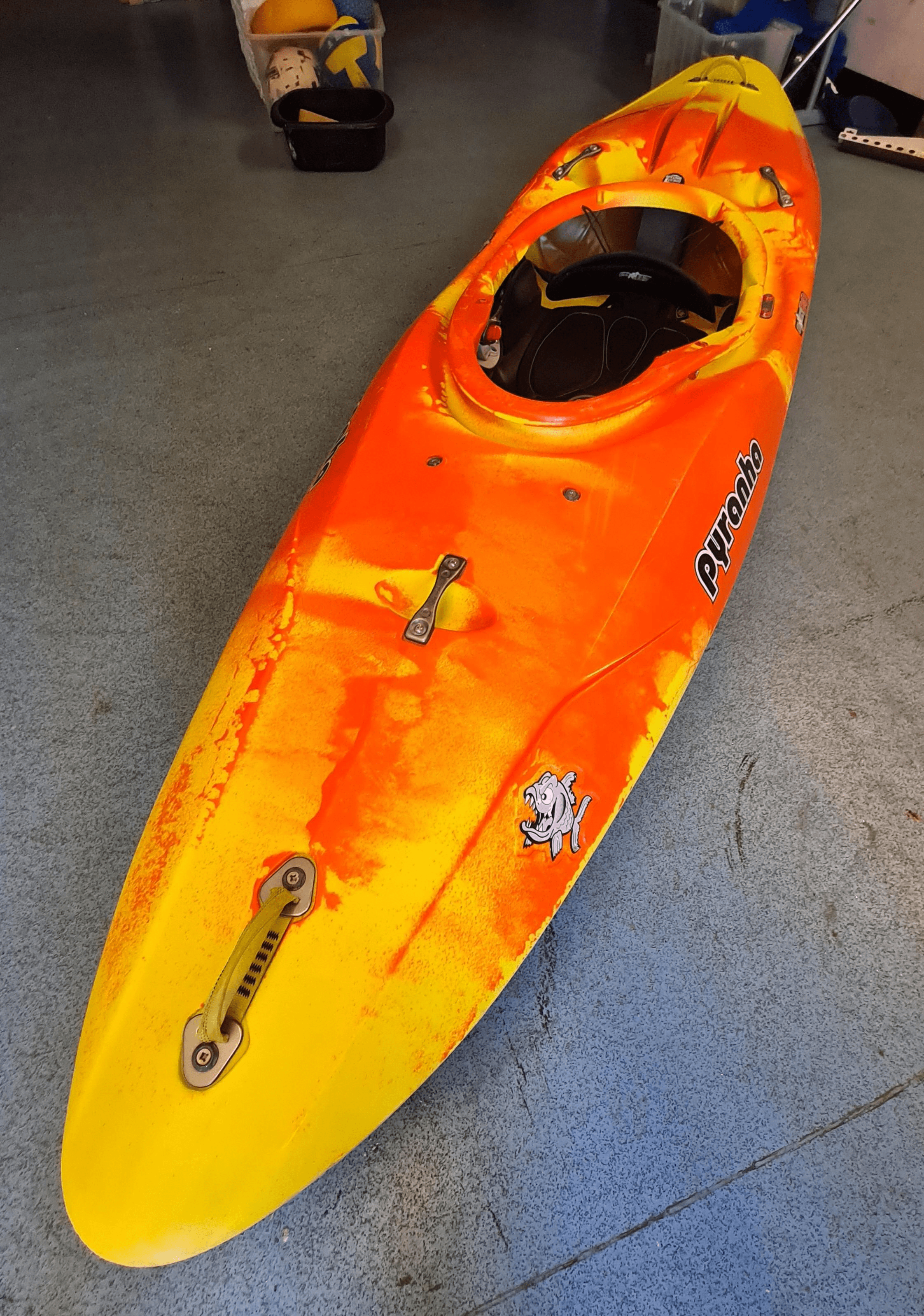 A orange and yellow kayakDescription automatically generated with medium confidence