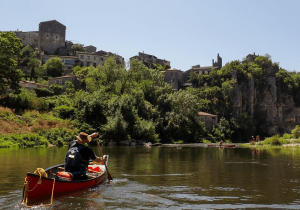 A person in a boat on a river Description automatically generated with low confidence