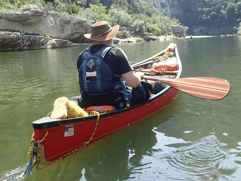 A person in a canoe on a riverDescription automatically generated with low confidence