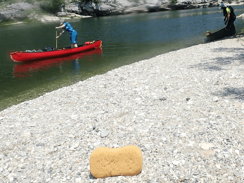 A person in a canoe on a riverDescription automatically generated with low confidence