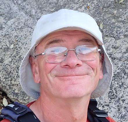 A person wearing a hat and glasses
Description automatically generated with medium confidence