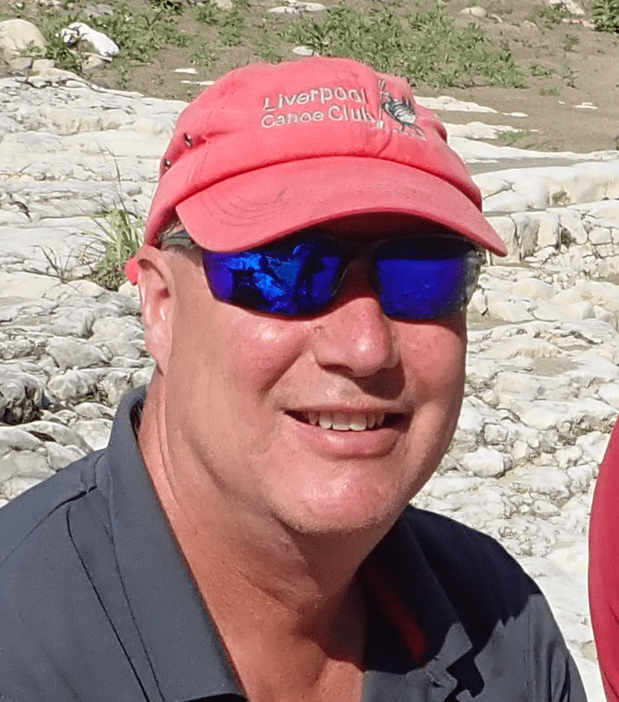 A person wearing a red hat and sunglassesDescription automatically generated with medium confidence