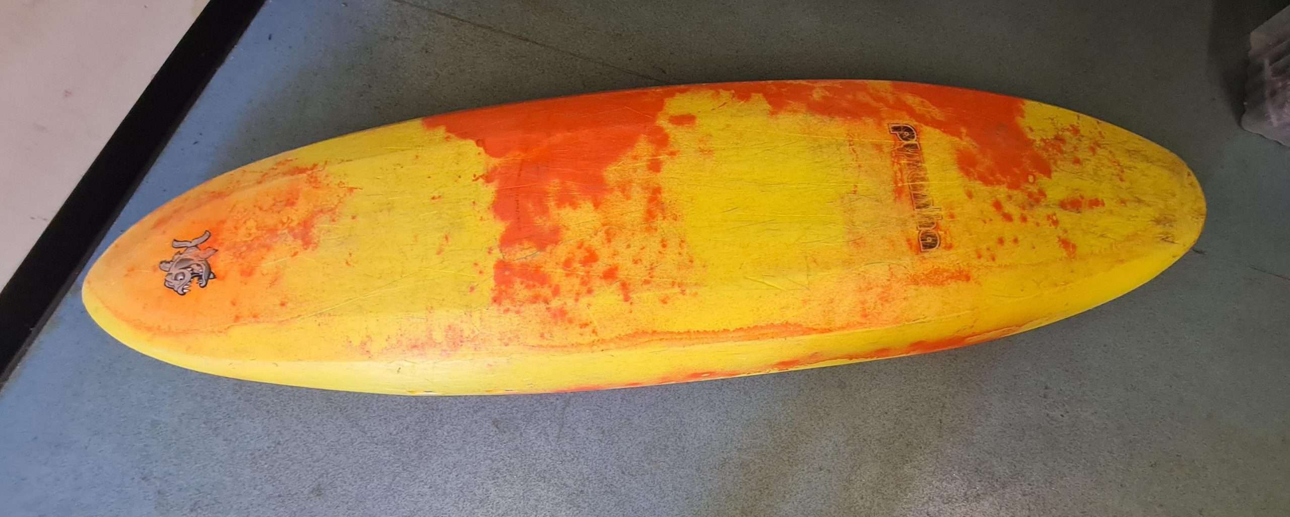 A yellow and orange surfboardDescription automatically generated with medium confidence