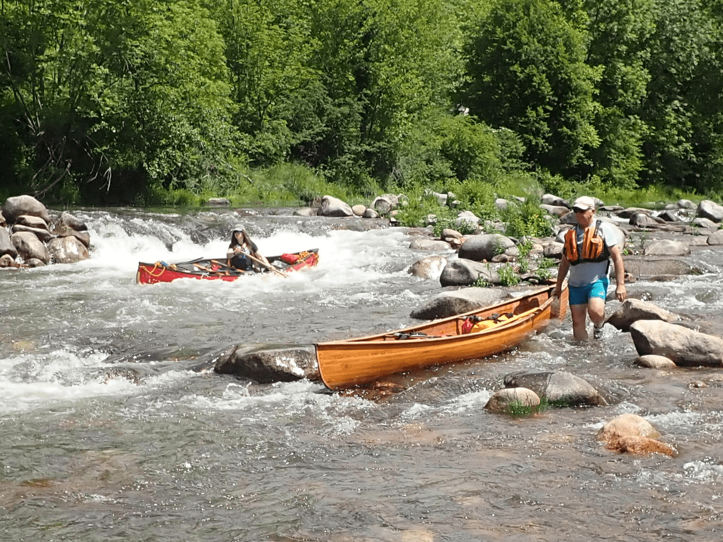 People kayaking in a riverDescription automatically generated with low confidence