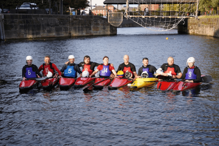 A group of people in kayaks on water Description automatically generated