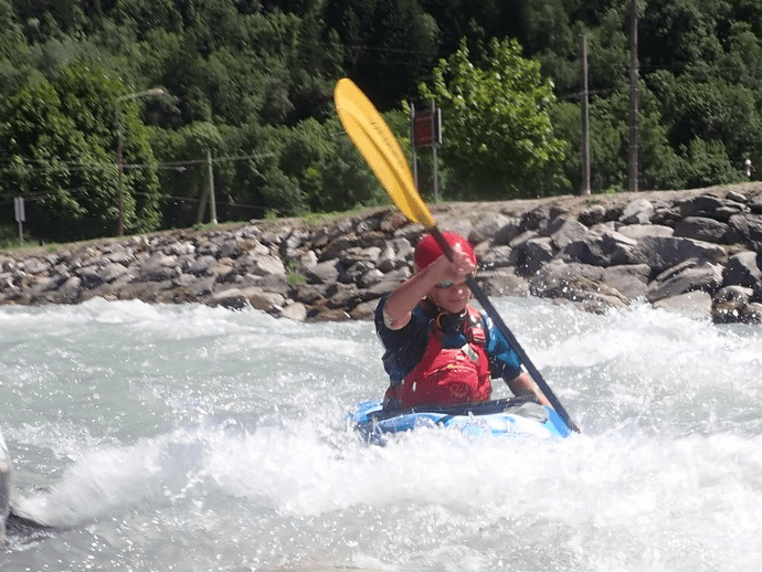 A person in a kayak on a riverDescription automatically generated