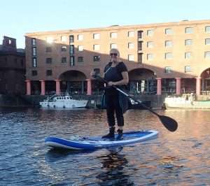 A person on a paddle board Description automatically generated