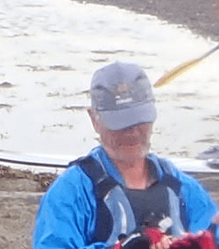 A person wearing a hat and a blue jacketDescription automatically generated