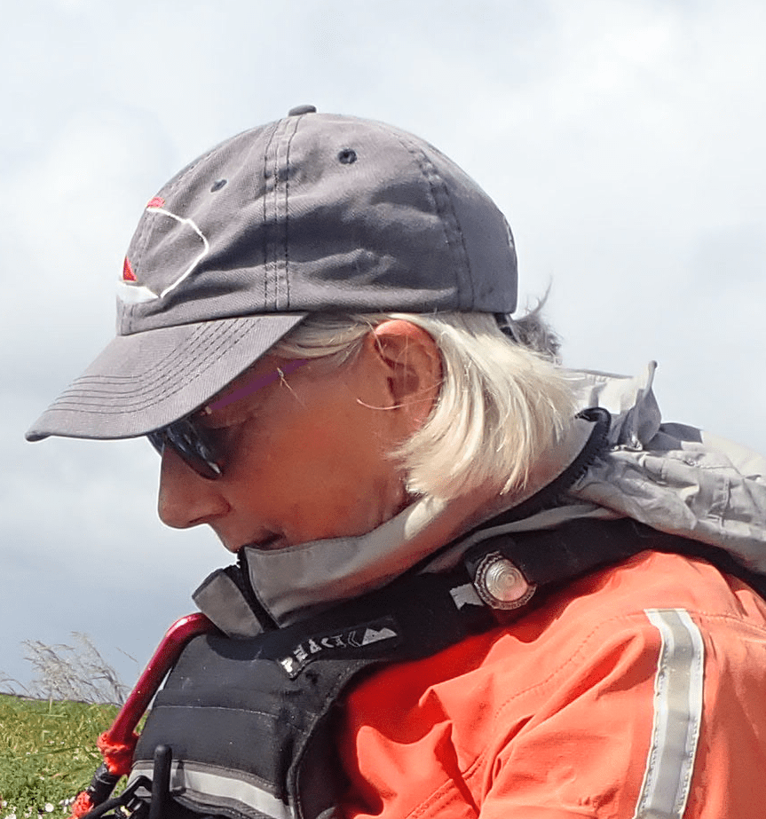 A person wearing a hat and sunglassesDescription automatically generated