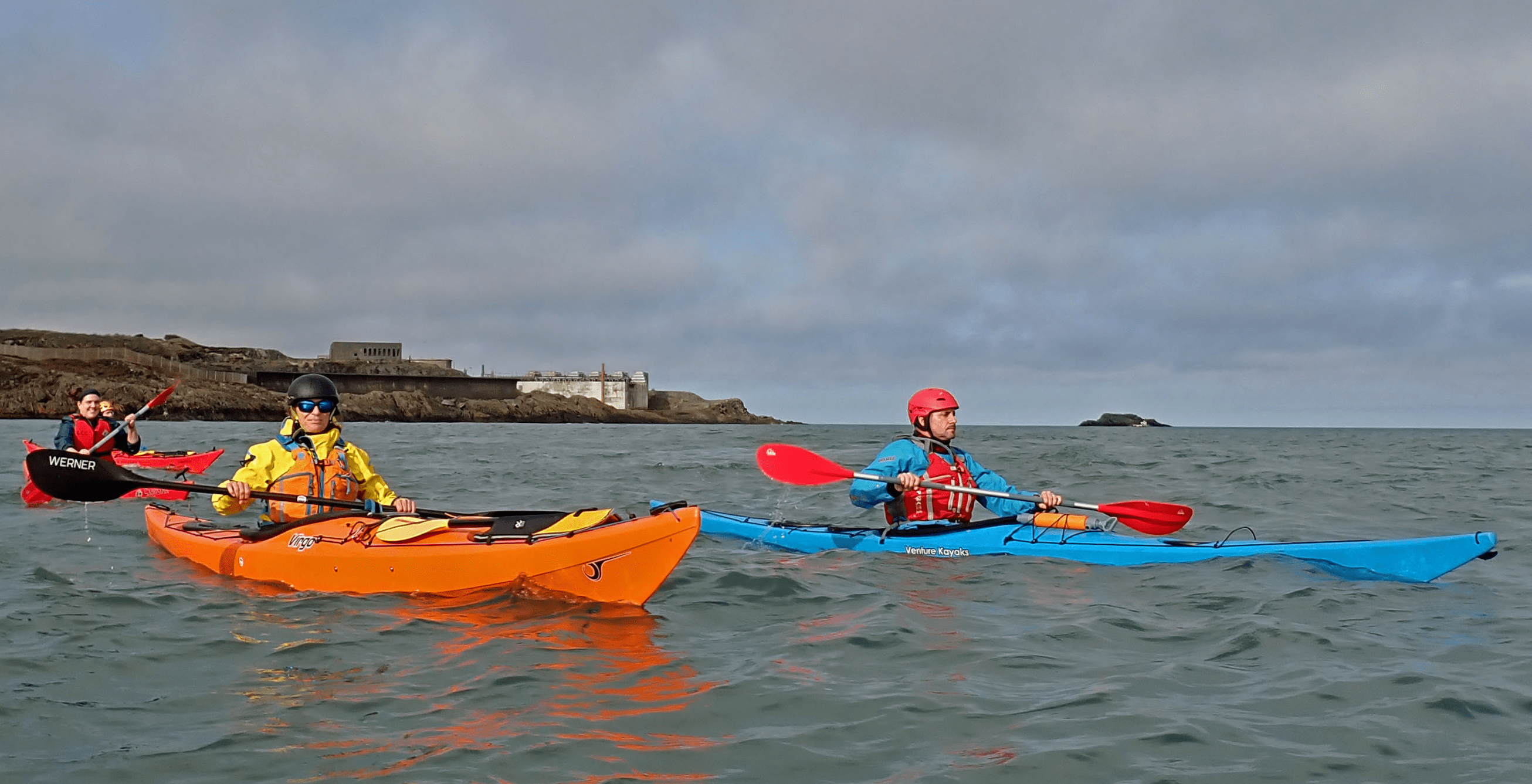 A couple of people in kayaks on the waterDescription automatically generated
