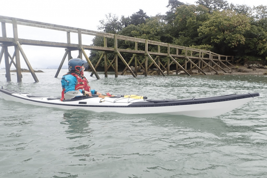 A person in a kayak on the water Description automatically generated