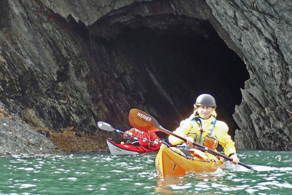 A person kayaking in a cave Description automatically generated