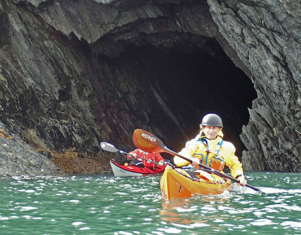 A person kayaking in a caveDescription automatically generated