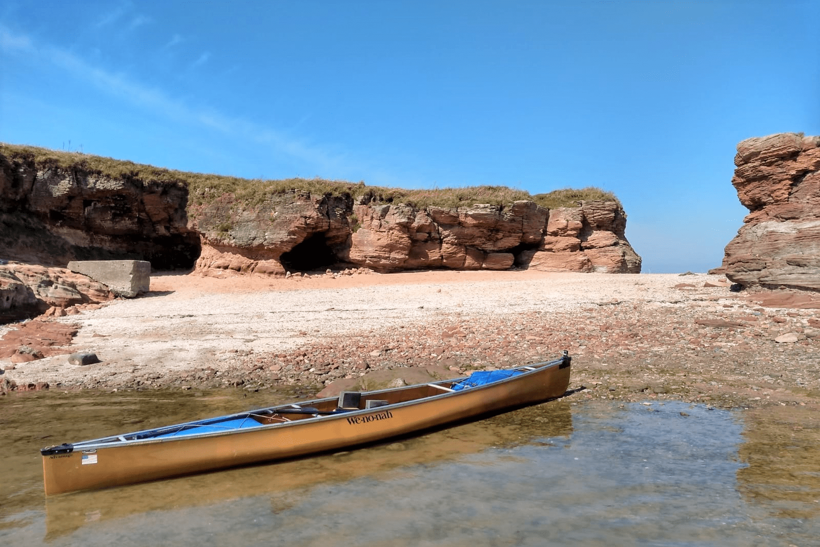 A canoe on a beachDescription automatically generated
