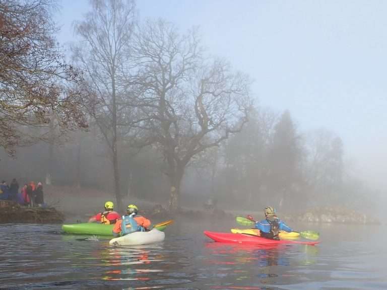 People kayaking on a lake Description automatically generated