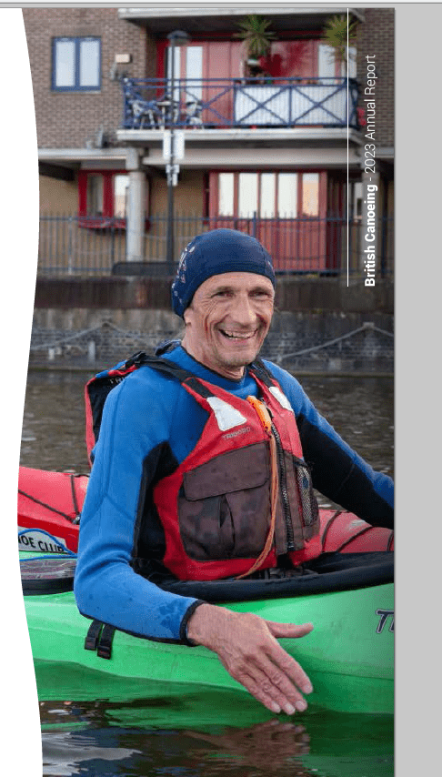 A person in a life jacket and hat smilingDescription automatically generated