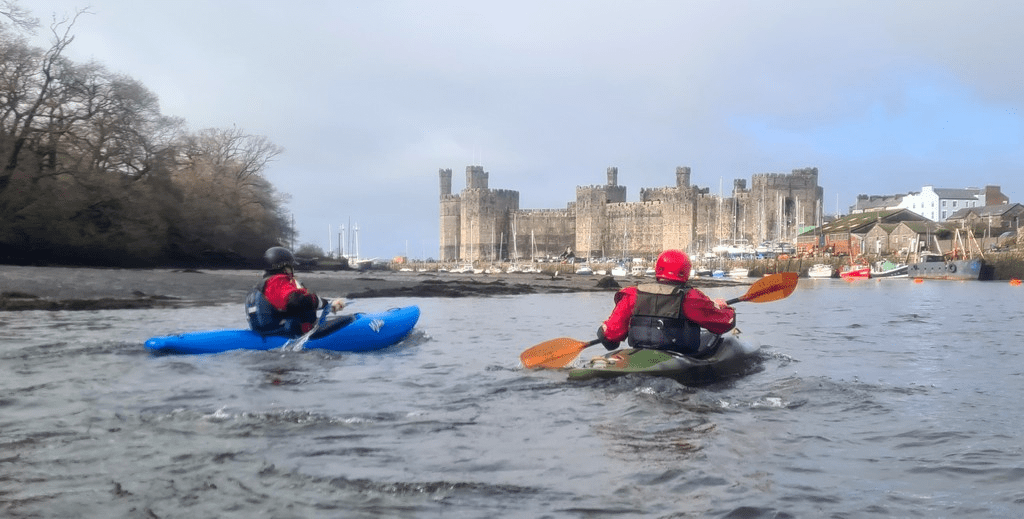 People kayaking in the waterDescription automatically generated