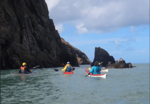 People kayaking in the water Description automatically generated