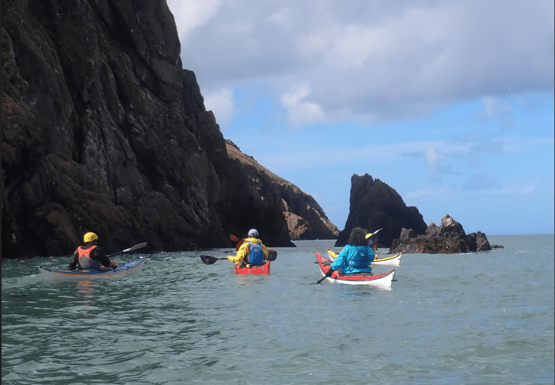 People kayaking in the waterDescription automatically generated