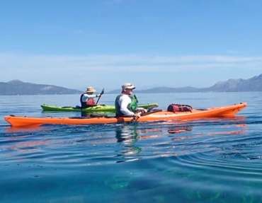 A couple of people in kayaks on the water

Description automatically generated