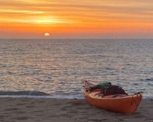 A kayak on a beach Description automatically generated